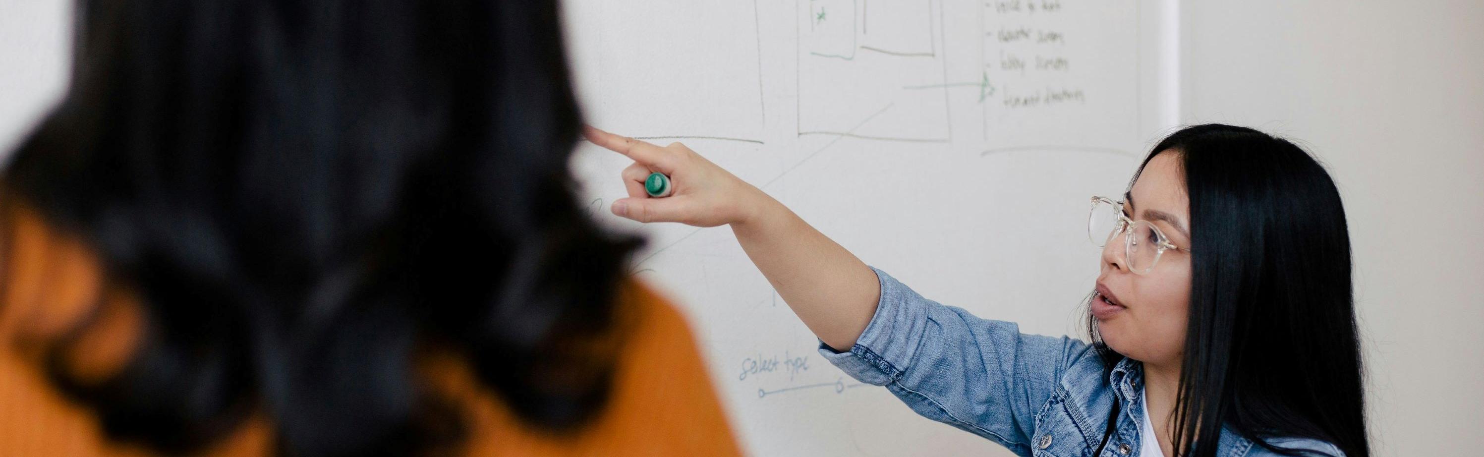 Instructor at a white board